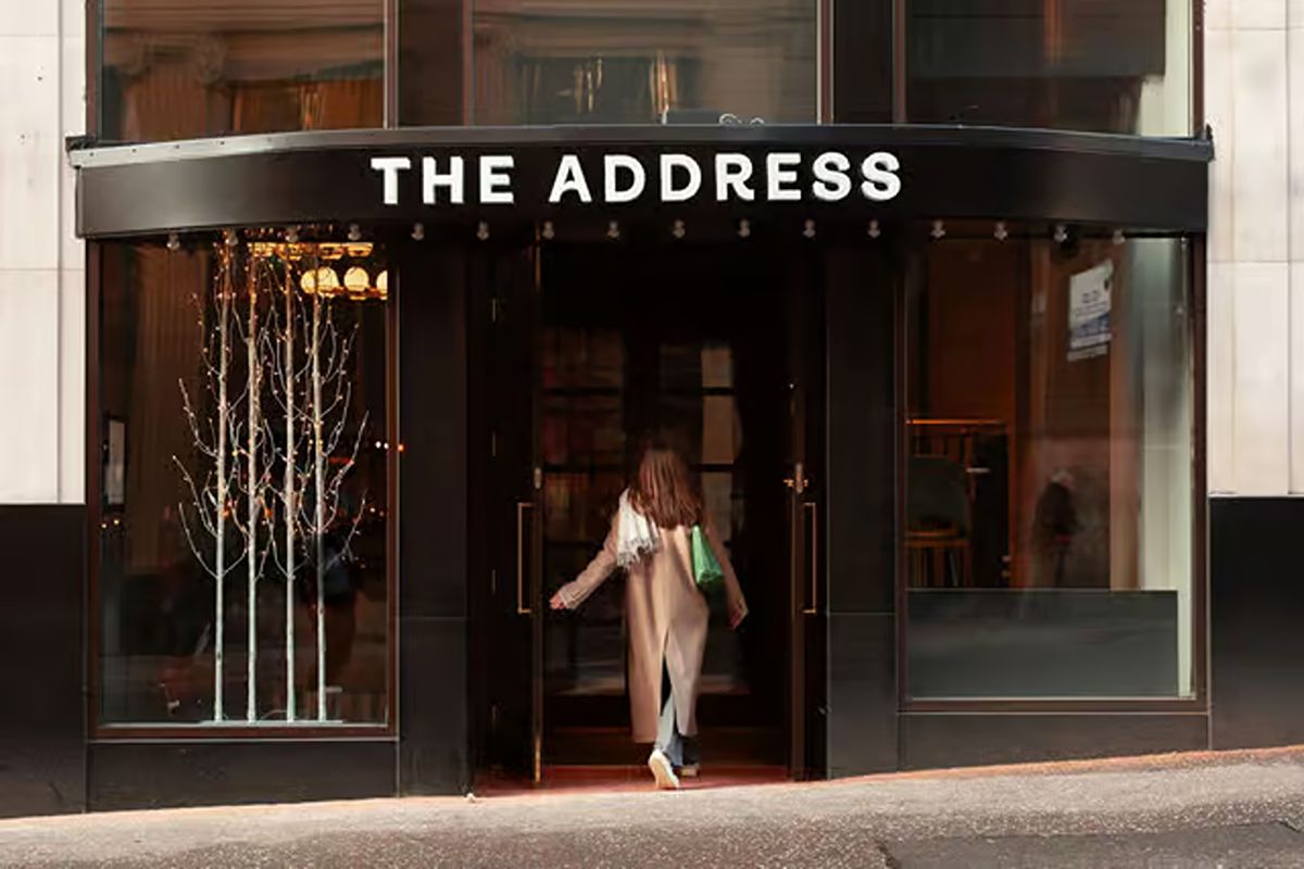 Entrance to The Address Wren Glasgow above Central Station, with a sleek black frontage and boutique city-centre feel.
