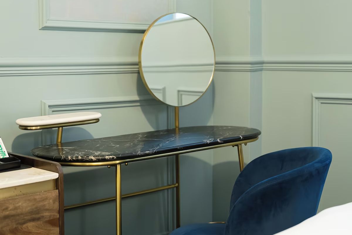Dressing area at 19 Duke Street Liverpool with brass details and rich blue seating.