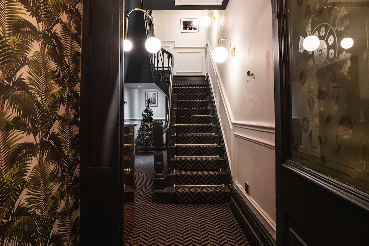 Interior staircase at 19 Duke Street Liverpool with dramatic wallpaper.