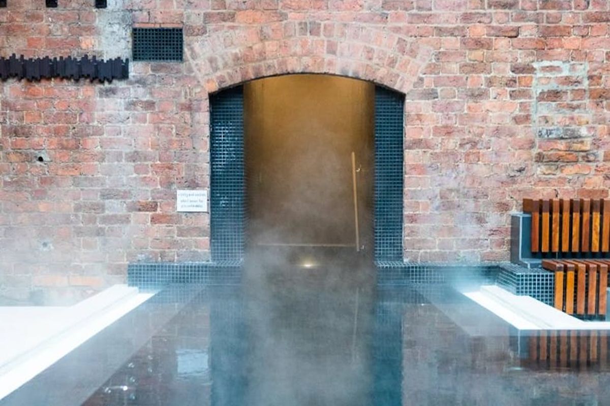 Spa pool at Hope Street Hotel with atmospheric lighting and exposed brick.