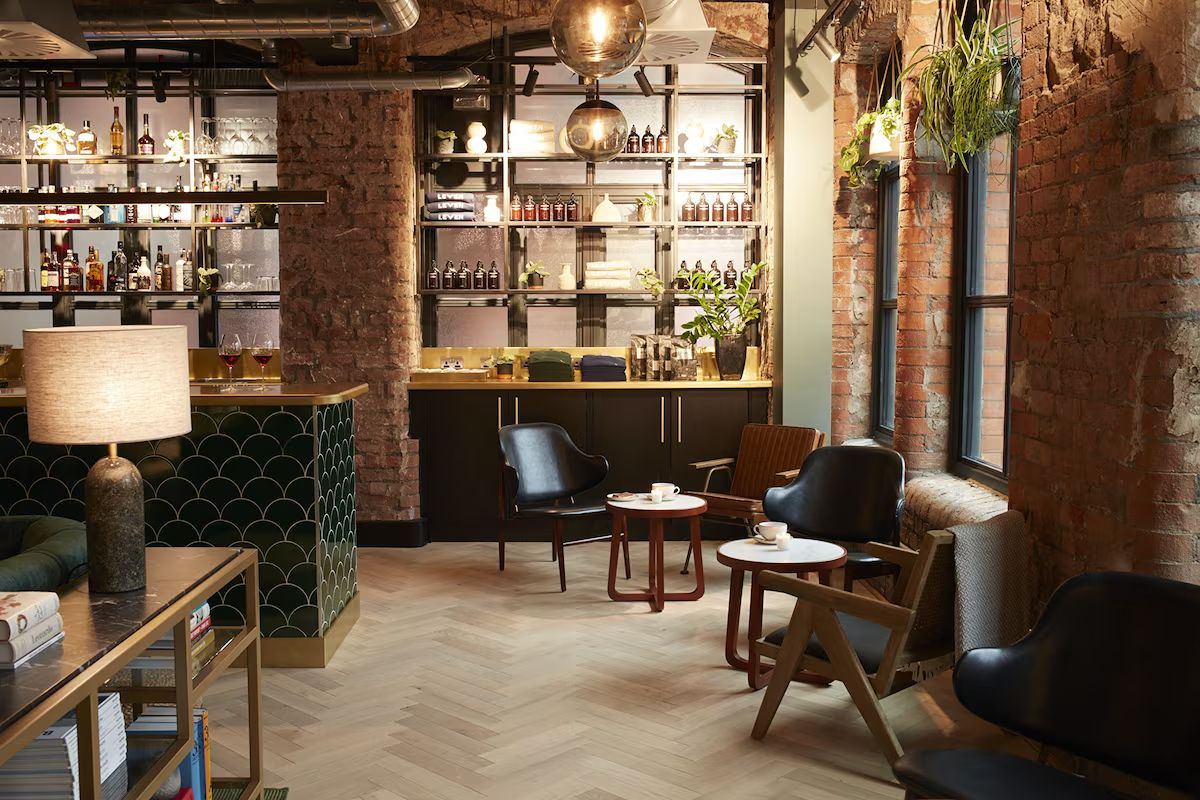 Lounge and bar at LEVEN Manchester, a stylish Manchester hen weekend hotel with exposed brick, warm lighting and relaxed contemporary seating.